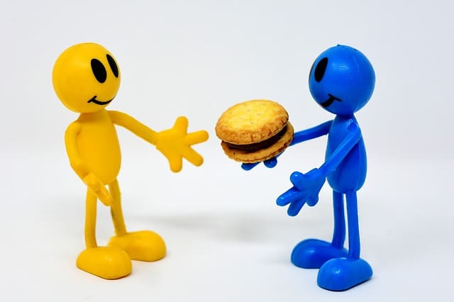 photo of friends sharing a cookie